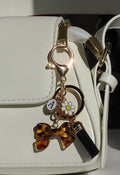 Goudkleurige Tashanger/Sleutelhanger met Leopard Strik, Kralen en Kwastje